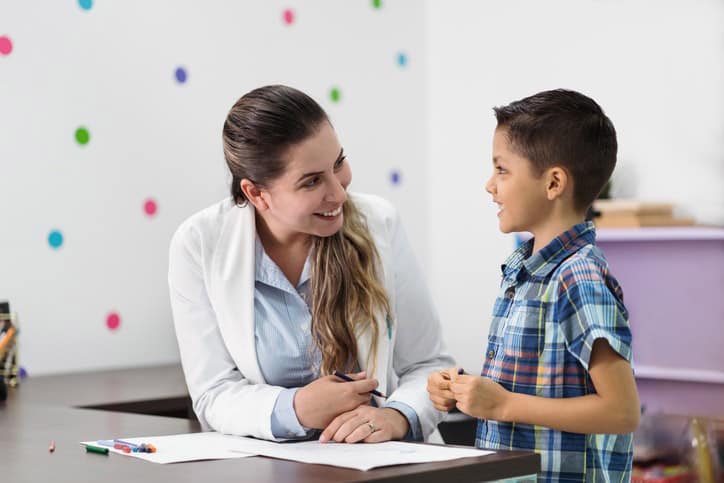 Happy psychologist and little boy smiling at each other Child Counseling Troy MI